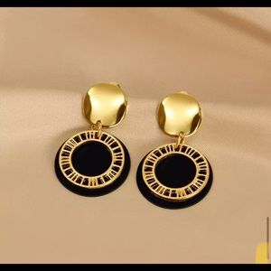 Black and gold geometric dangle earrings.